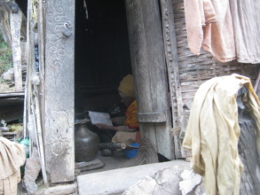 An old woman reading  in  her room