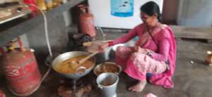 A woman preparing food for the elderly people