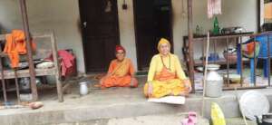 Two oldest women sitting in front of their Kutis
