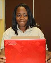 Domineisha receives a laptop from Microsoft