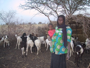 Mother and child with goats