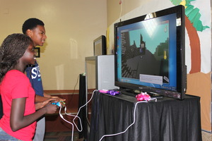 Teens playing Josh's Kodu game at Gaining STEAM!