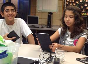 GrubClub participants using tablets to edit photos