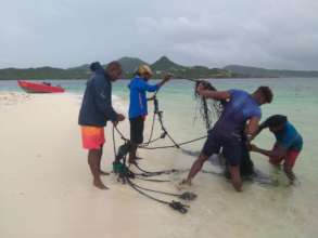Removing a fish trap. Photo: Davon Baker