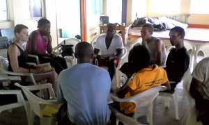 A workshop group discusses a plan of action.