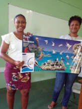 A teacher receives seabird posters and curriculum.