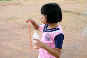 Blowing bubbles at Koung Jor refugee camp
