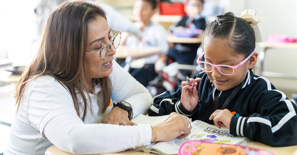 Teacher and first grade student in Mexico