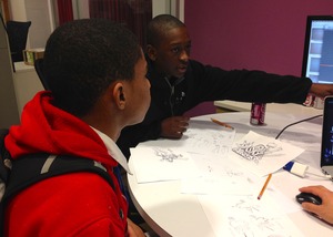 Zavonie explains his video game project to a peer