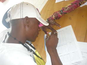 Beneficiary working with the team in the meetings