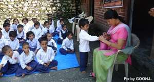 Teacher ensuring hygiene of the children