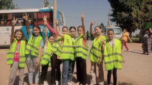 Girls during shelter installation at bus station