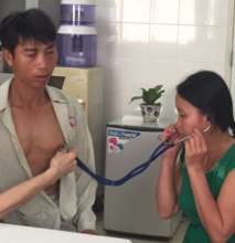 Vinh's wife listens to his heart pre-surgery