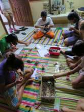 The girls enjoy making colorful bracelets