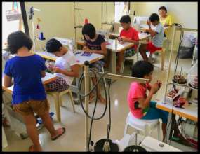 The girls work hard to learn sewing skills