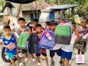 Kids clasping their new schoolbags