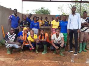 students in front of their compost batch