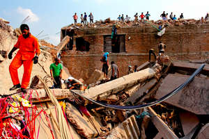 Rescue workers search through the factory rubble