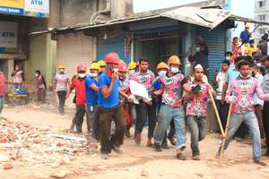First responders rush a survivor from the ruins