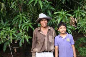 Father & Son in front of their growing mango trees