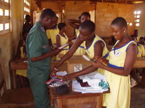 Children receive pens for creative writing