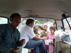 Doctor dispensing medicines from the back of a van