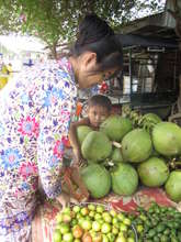 Woman tending to her fruit stand