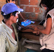 Health Promoter checks blood pressure