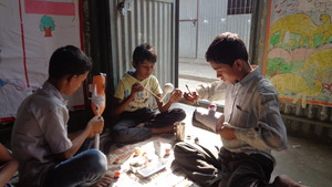 Children working hard to make their puppets