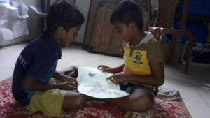 Child enjoying reading of storybook with a friend