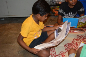 A child from a centre trying to read the book
