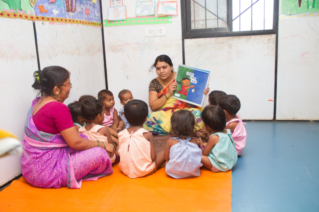 Teacher reading story to our creche section !