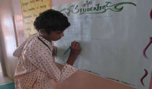 Student writes in the chart - 1