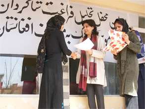 Hassina Sherjan issuing diplomas to graduates