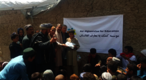 Children receiving learning kits in an IDP camp