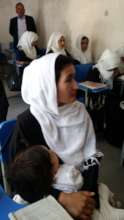 A mother brings her child to school with her.