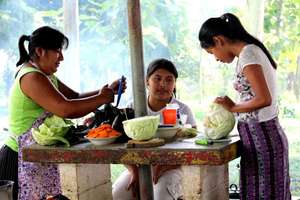 Cooking their specialties at an outdoor event