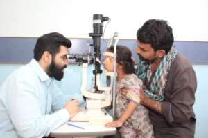 Young Naz being examined with a slit lamp