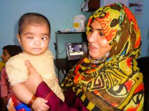5 months old, Ayesha in her mother's lap
