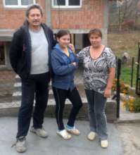 Sanja with her parents in front of the new house