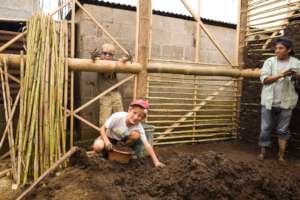 volunteers help with mud work on walls