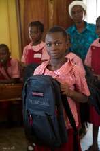 A Primary Student Proudly Shows Off Her Backpack