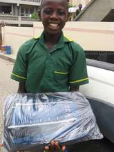 Student receiving new school bag from CH staff