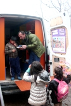 Ilir helps a boy choose his book