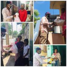 Volunteers giving groceries to centre management