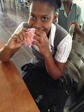 A student enjoying a peanut butter sandwich