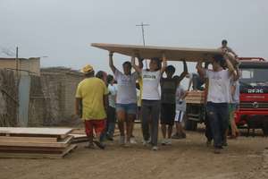 Unloading 1 of the 3 floor panels for a house.