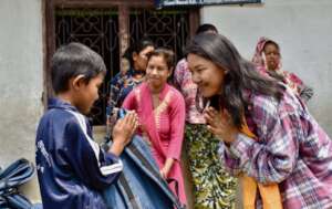Manju gifting school supplies to school children