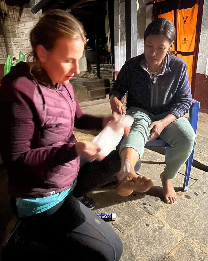 Volunteer Doctor bandaging a leg