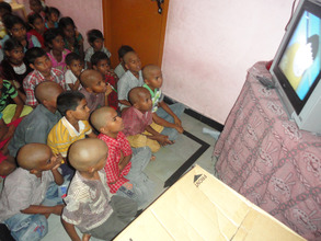 Orphan Children enjoying while watching the TV